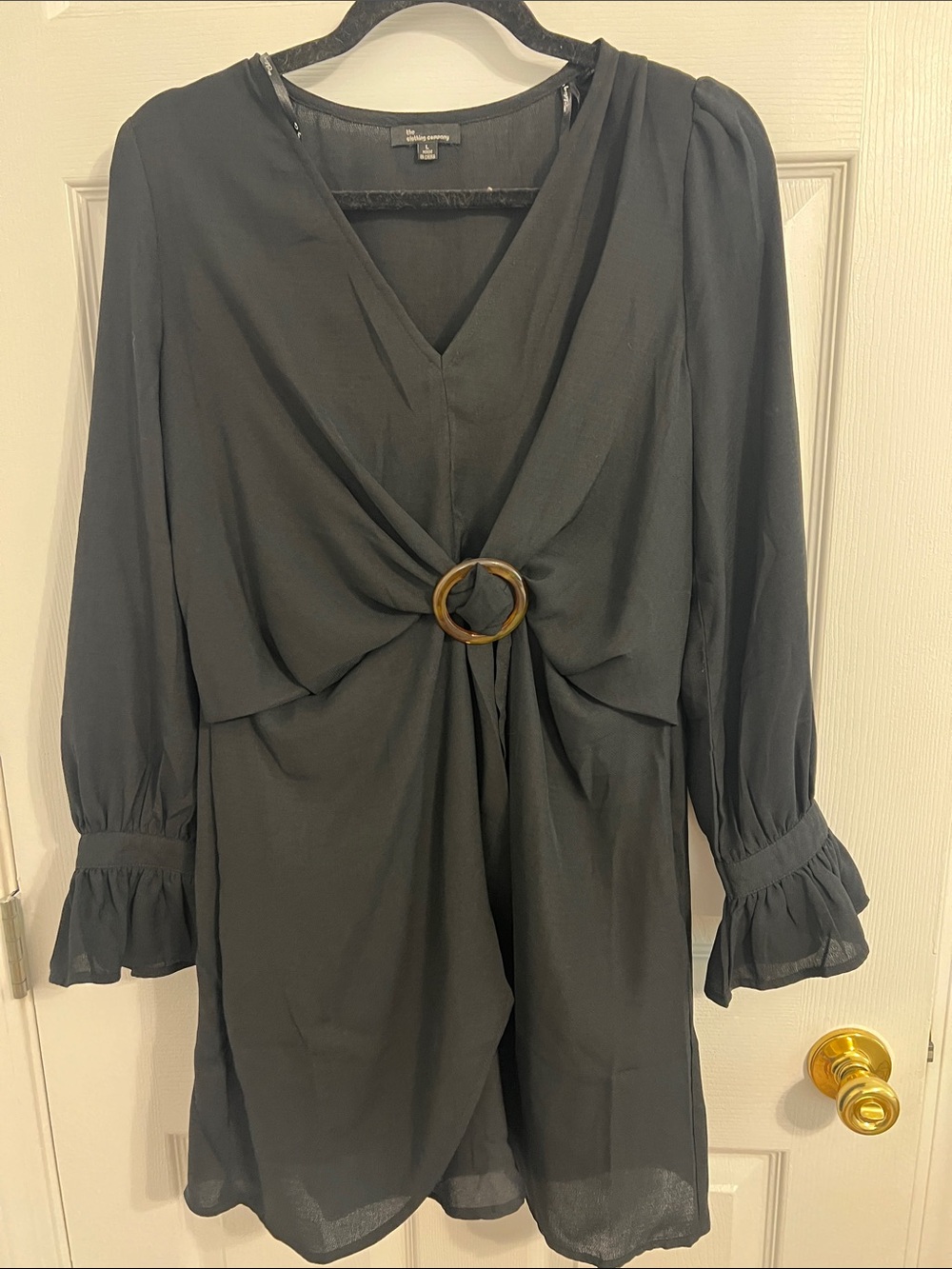 the clothing company Black Long-Sleeve Wrap Dress with Gold Ring Detail